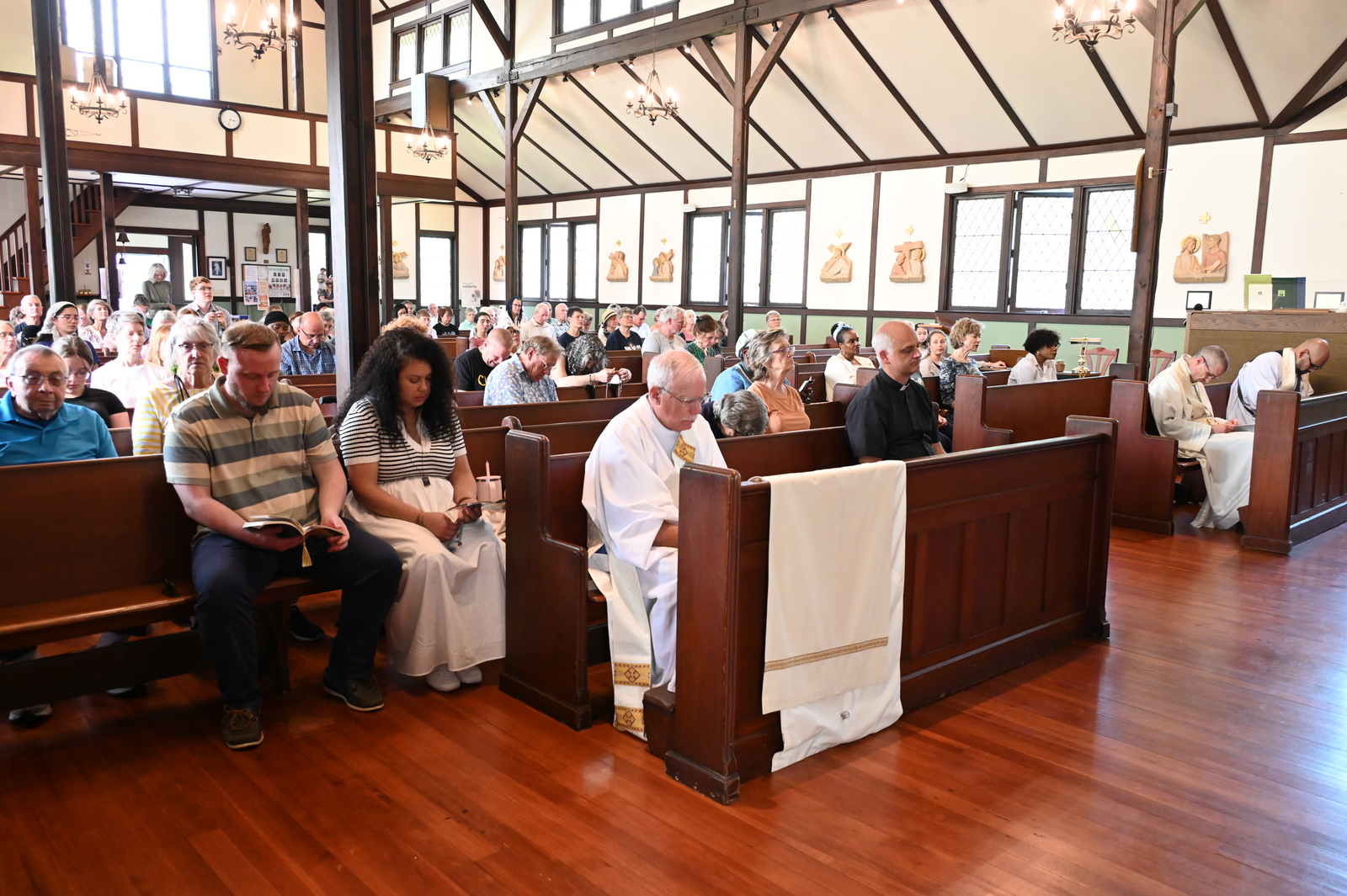 People in pews at St. Christopher Church on Peaks Island
