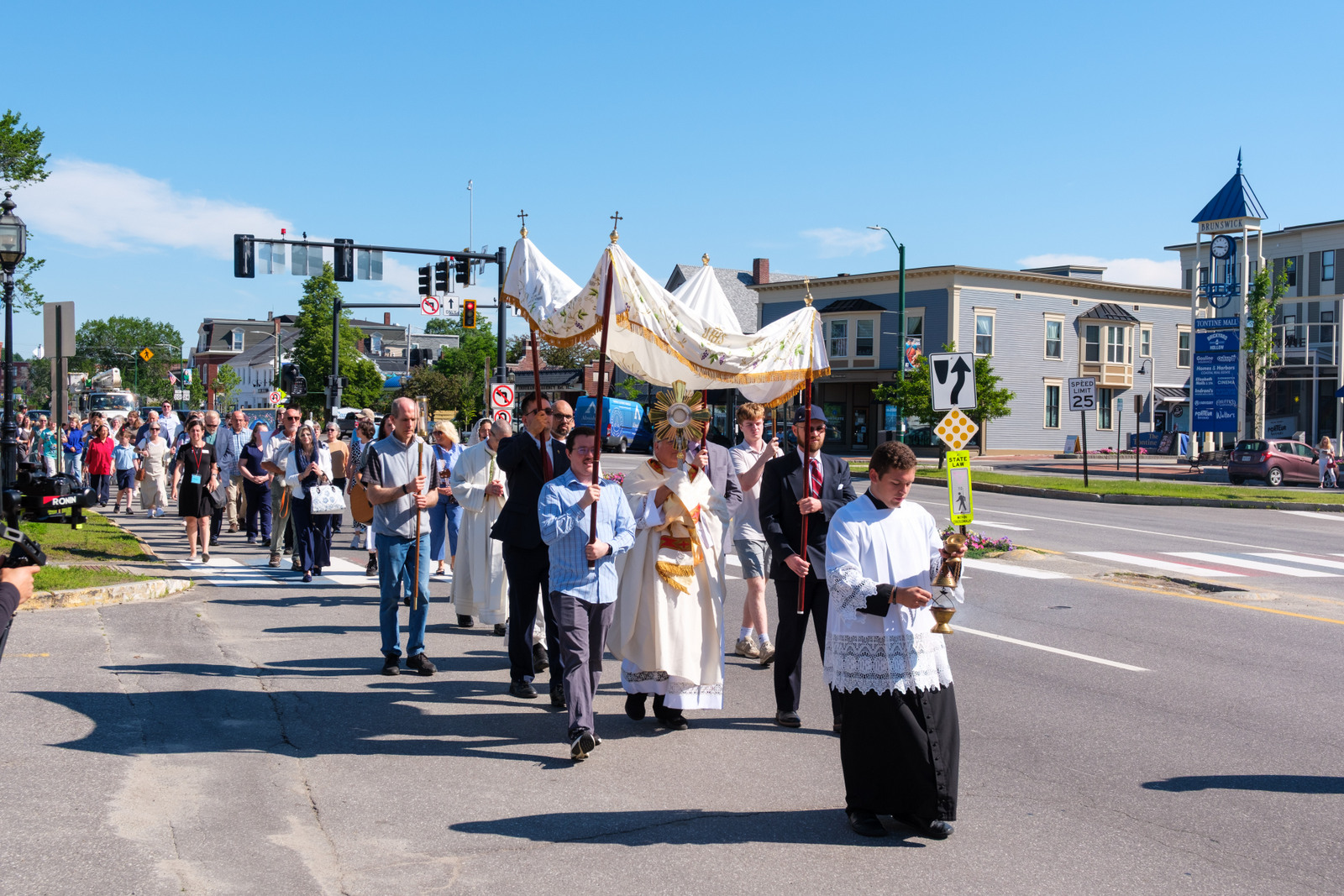 Eucharistic procession through the streets of Brunswick, showing Father Tracy with the monstrance.