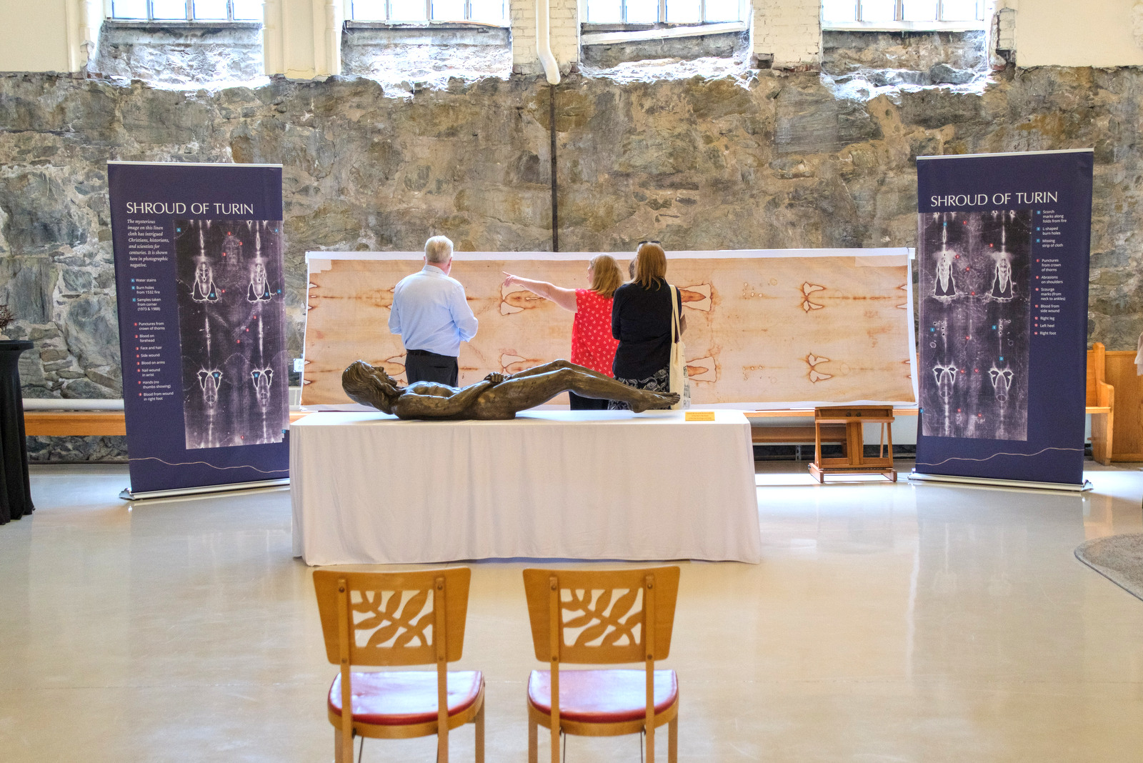Two people viewing Shroud of Turin Replica at the Basilica in Lewiston.