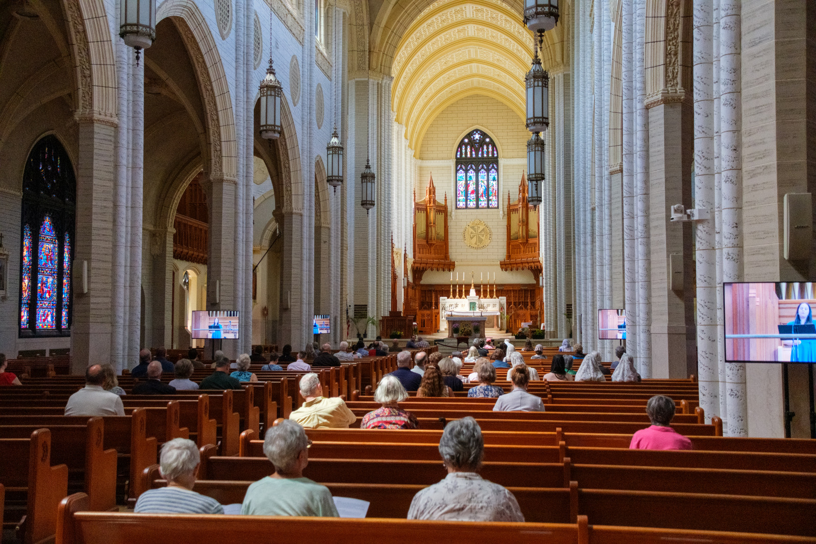 People in the pews at the Basilica of Ss. Peter & Paul in Lewiston.