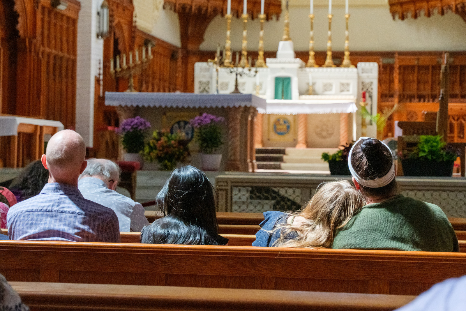 Four people in the pews at the Basilica of Ss. Peter & Paul in Lewiston.