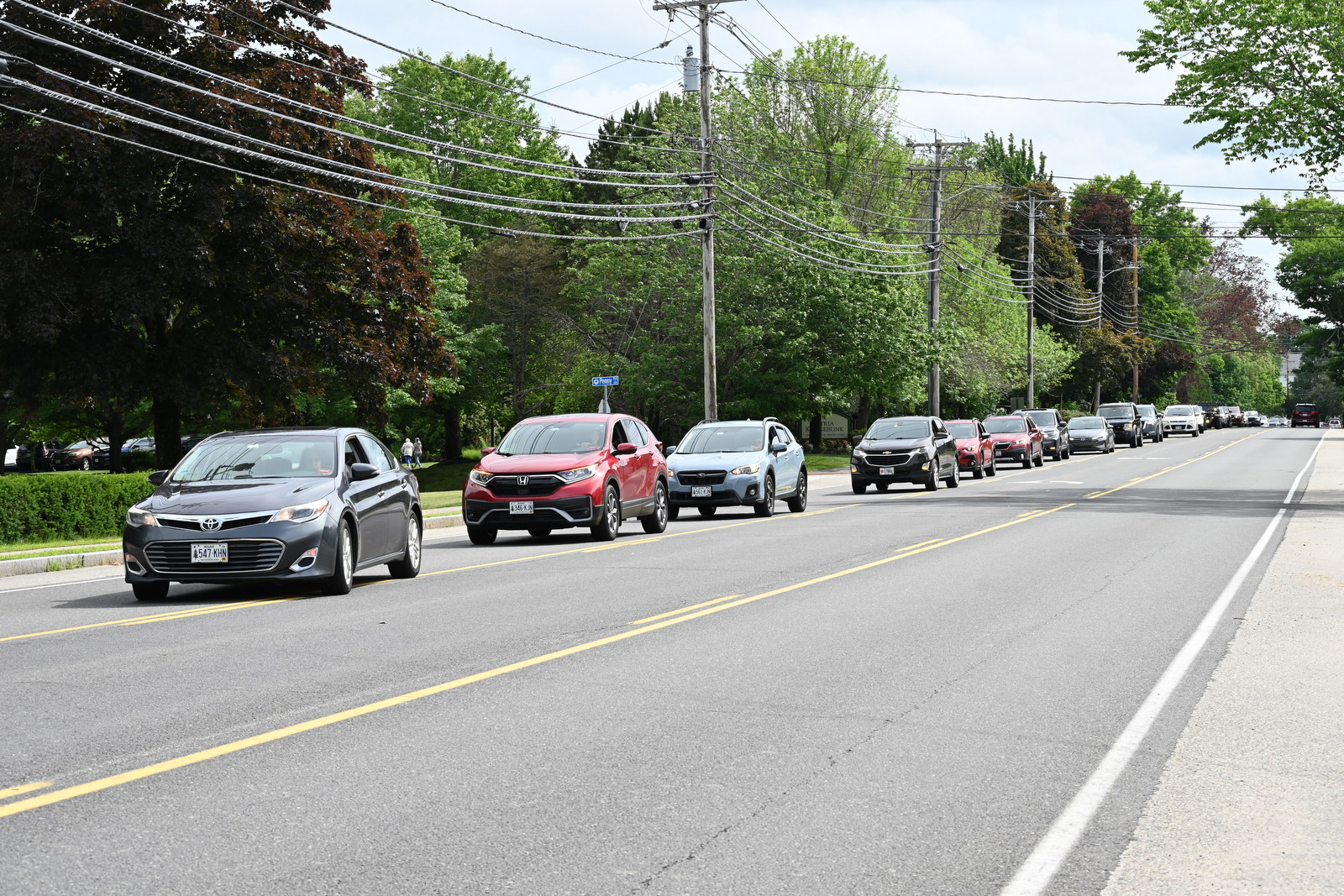 Car procession turning into St. Martha Church parking lot.