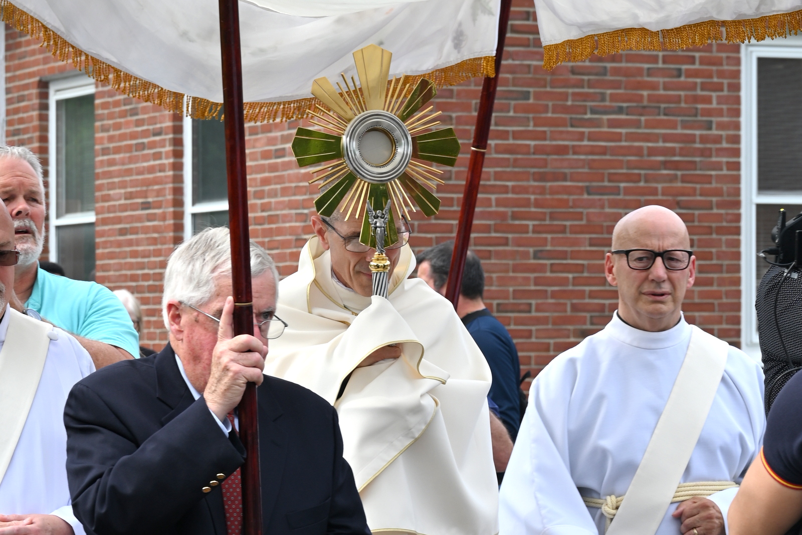 Bishop Ruggieri holding the monstrance in the eucharistic procession at St. Martha Church.