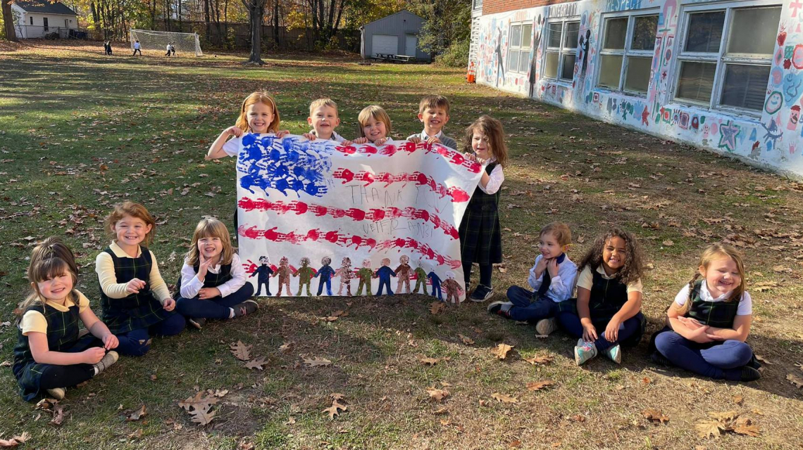 St. John's students display a homemade flag.