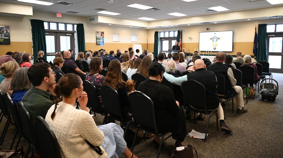Conference attendees listen to Bishop James Ruggieri.