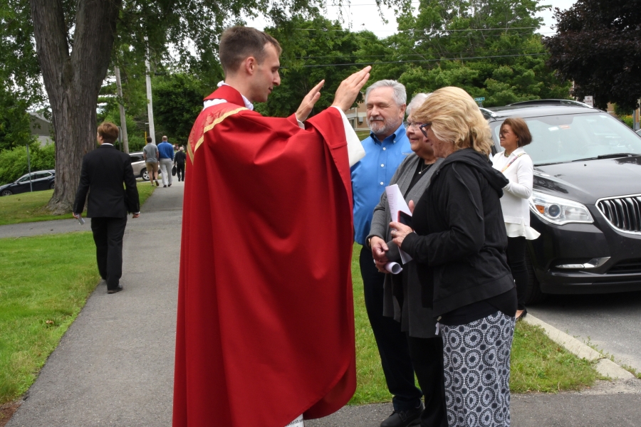 Father Matthew Valles blesses a couple after Mass.