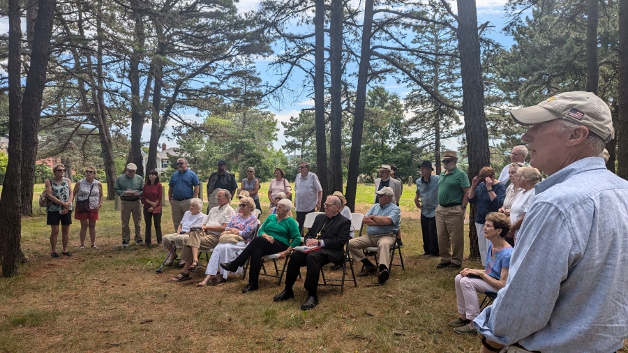 Group sitting in cemetery.