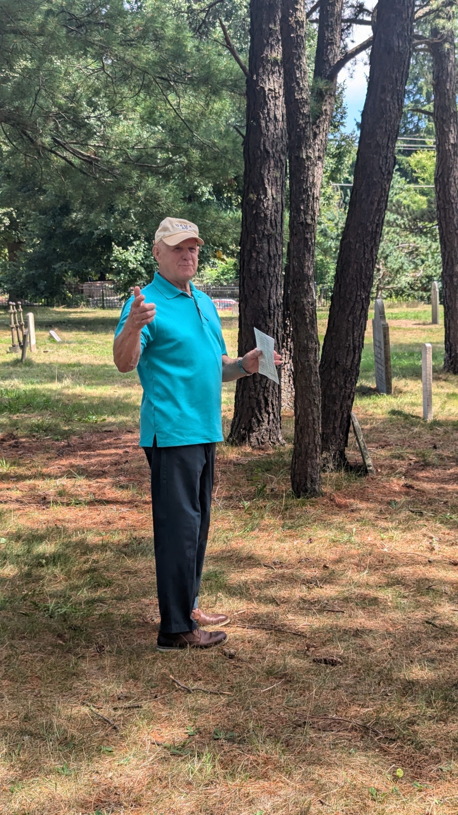 Man speaking in cemetery