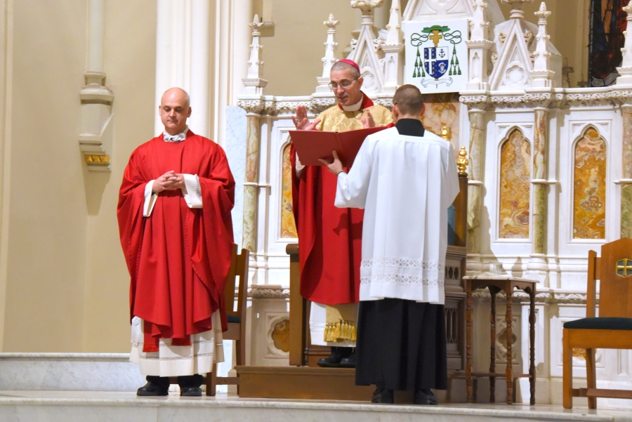 Bishop James Ruggieri offers the opening prayer. Father Seamus Griesbach stands to his right.