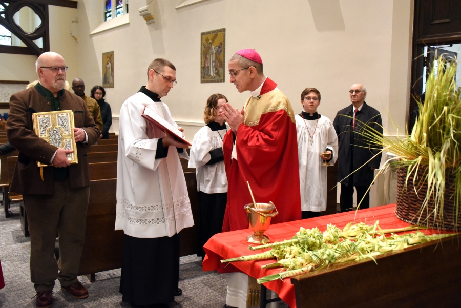Bishop James Ruggieri blesses palm branches.