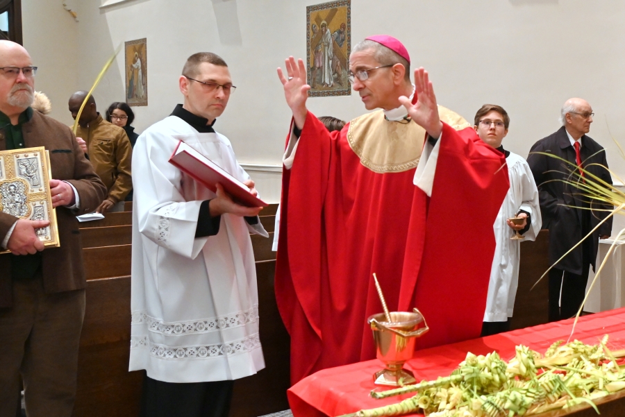 Bishop James Ruggieri blesses palm branches.