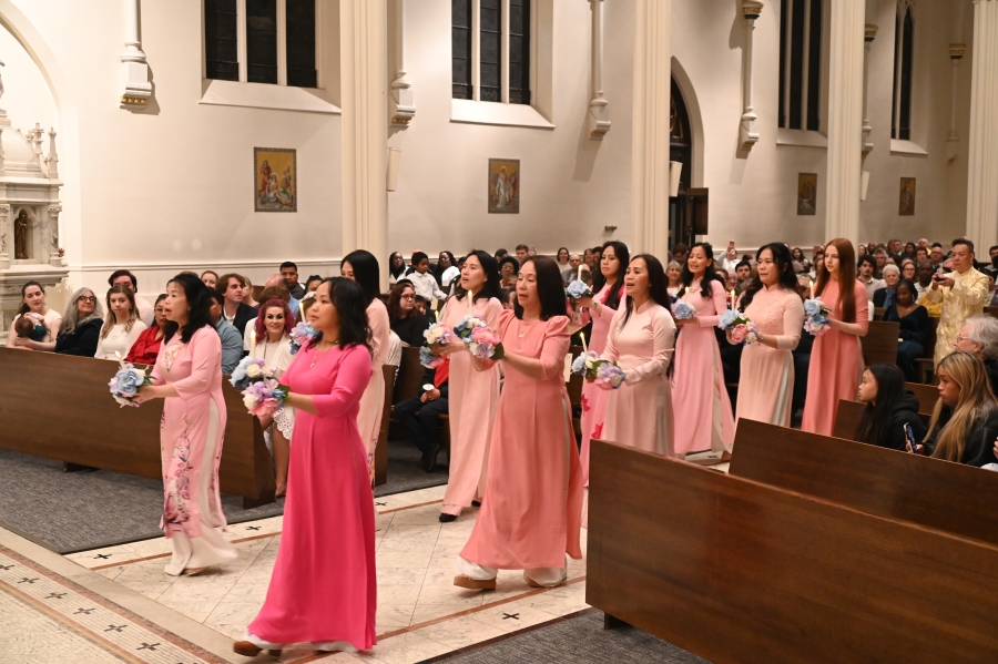 Women in pink dresses dance in aisle