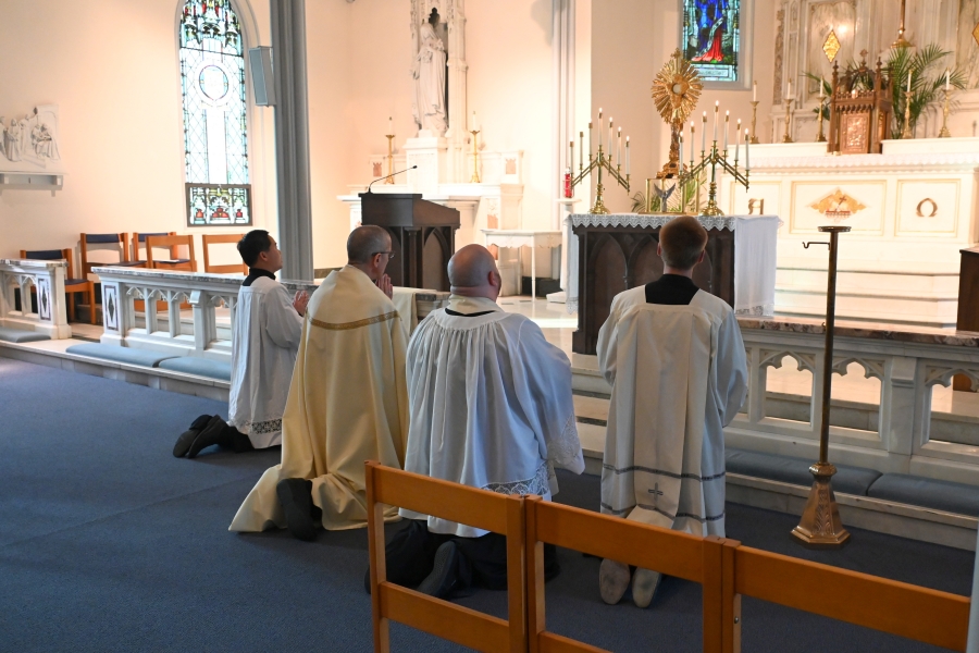 Kneeling before the altar and monstrance