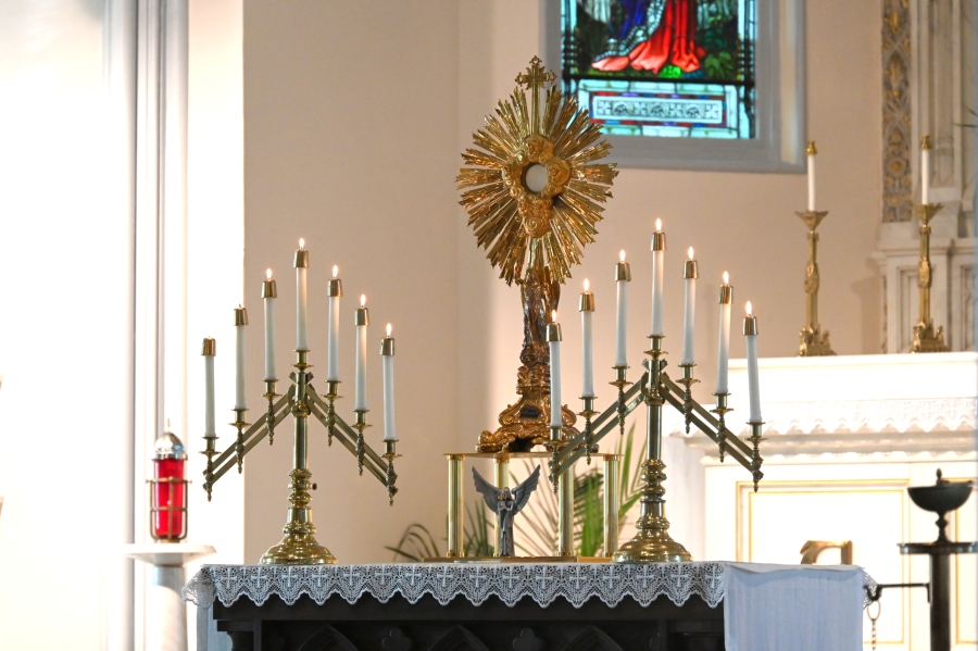 The monstrance holding the Blessed Sacrament surrounded by candles