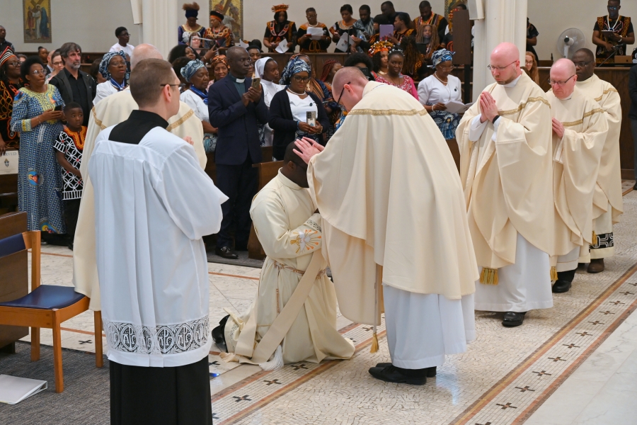 Priests lay hands on the ordinands.
