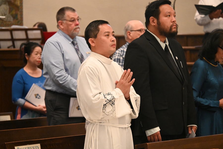 Vinh Nguyen standing with hands in prayer