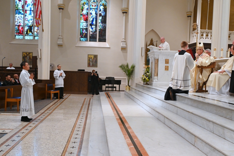Vinh Nguyen stands before the bishop.