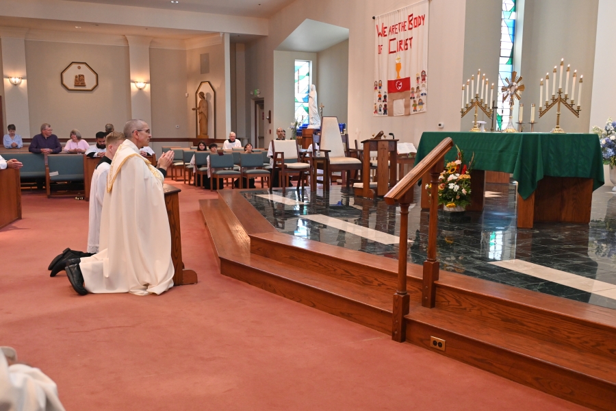 Bishop James Ruggieri incenses the altar and monstrance at the beginning of adoration at St. Martha Church.