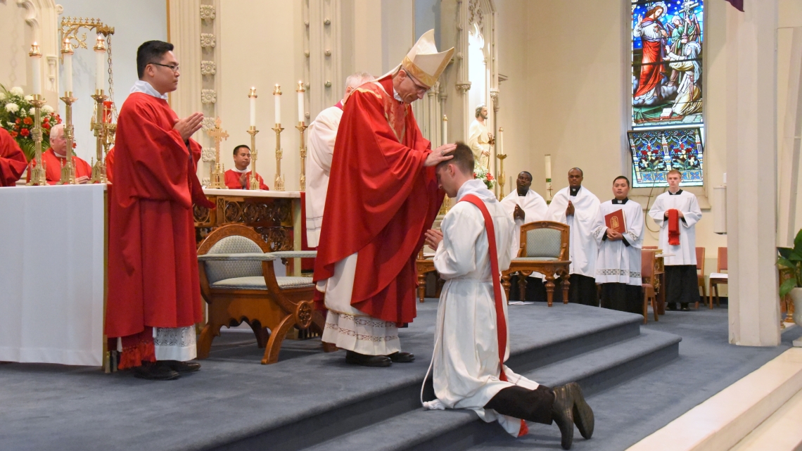Bishop James Ruggieri lays hands on Deacon Matthew Valles