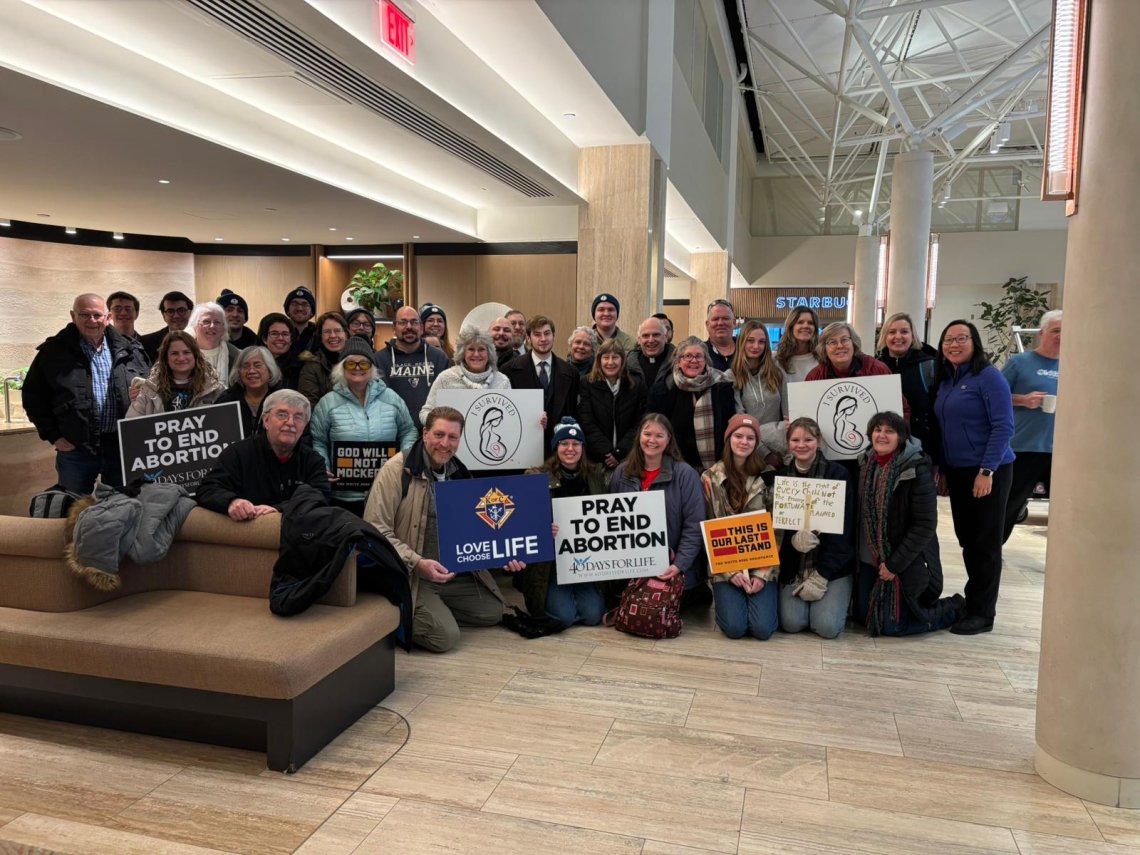 Group posed together in a hotel lobby