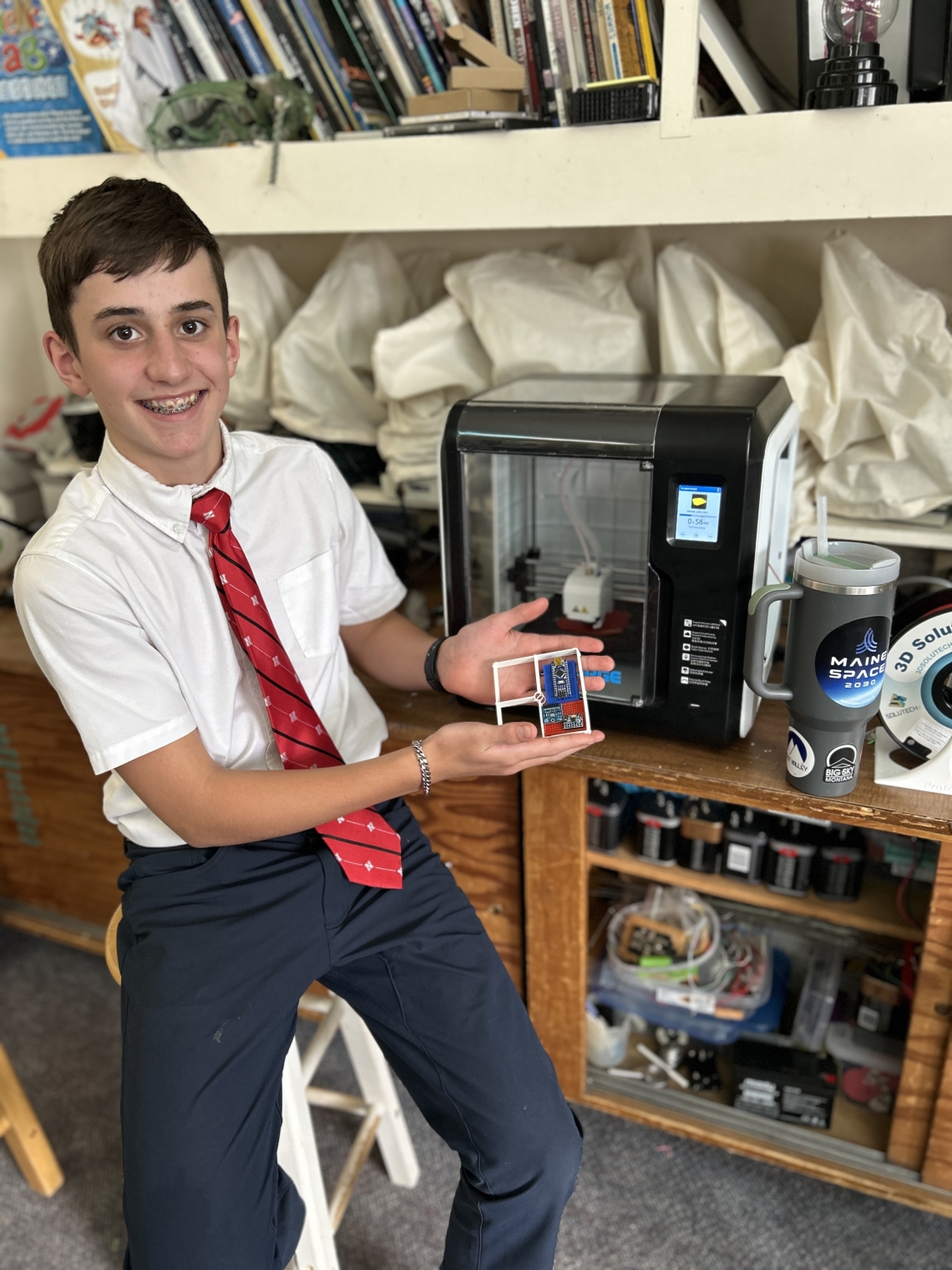 Joseph poses with a piece of his cubesat