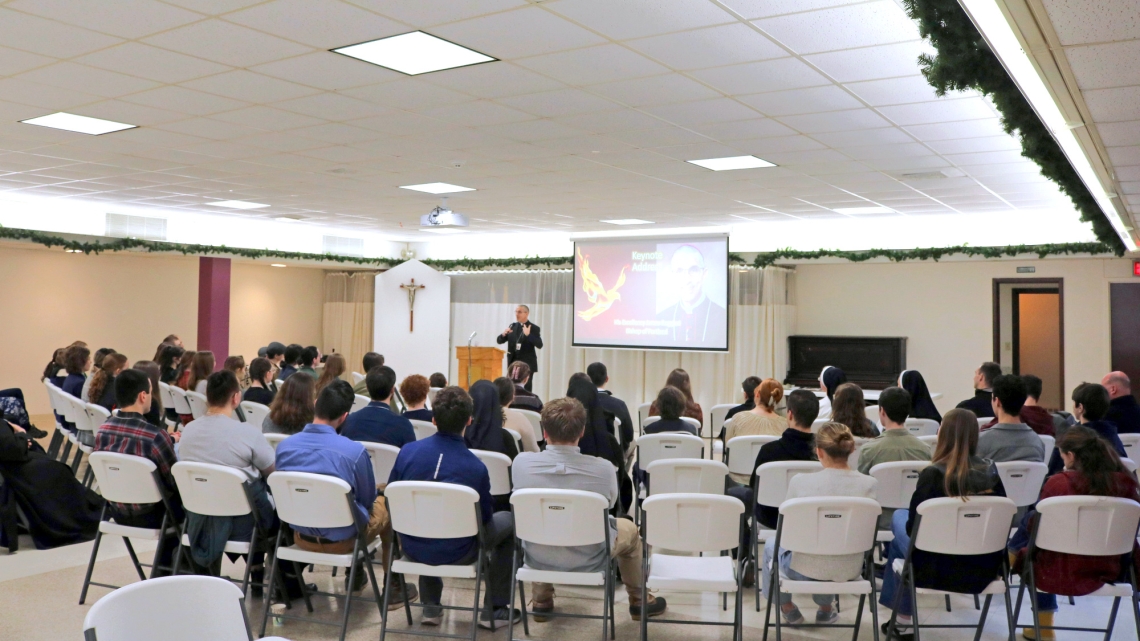 Teens and young adults listen to a keynote address by Bishop James Ruggieri.