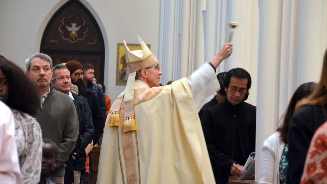 Bishop Ruggieri sprinkles the congregation with holy water.