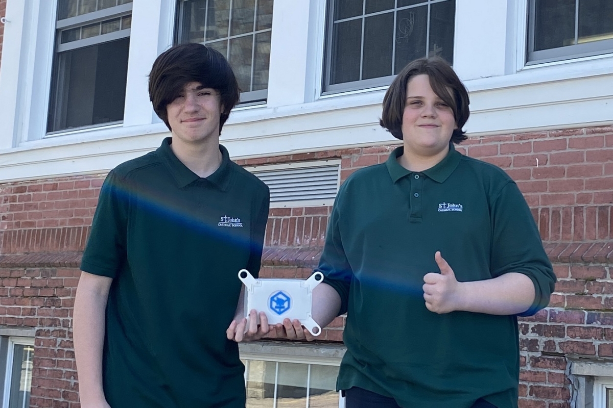 students holding small satellite