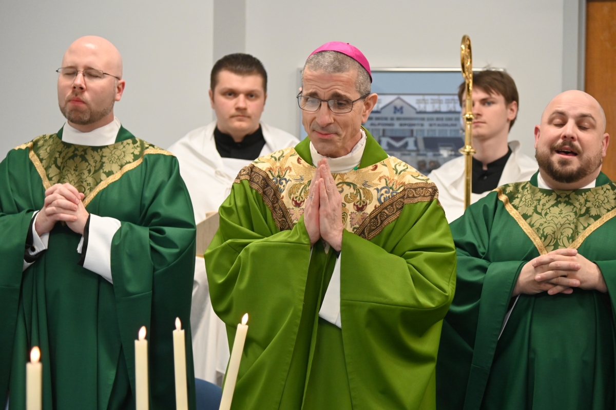 Bishop James Ruggieri, Father Kyle Doustou, Father Brad Morin, and student altar servers
