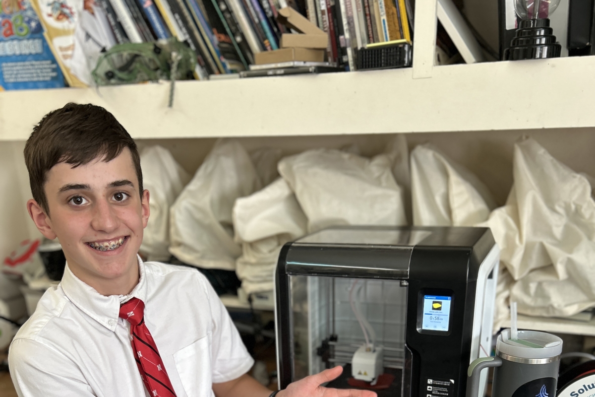 Joseph poses with a piece of his cubesat