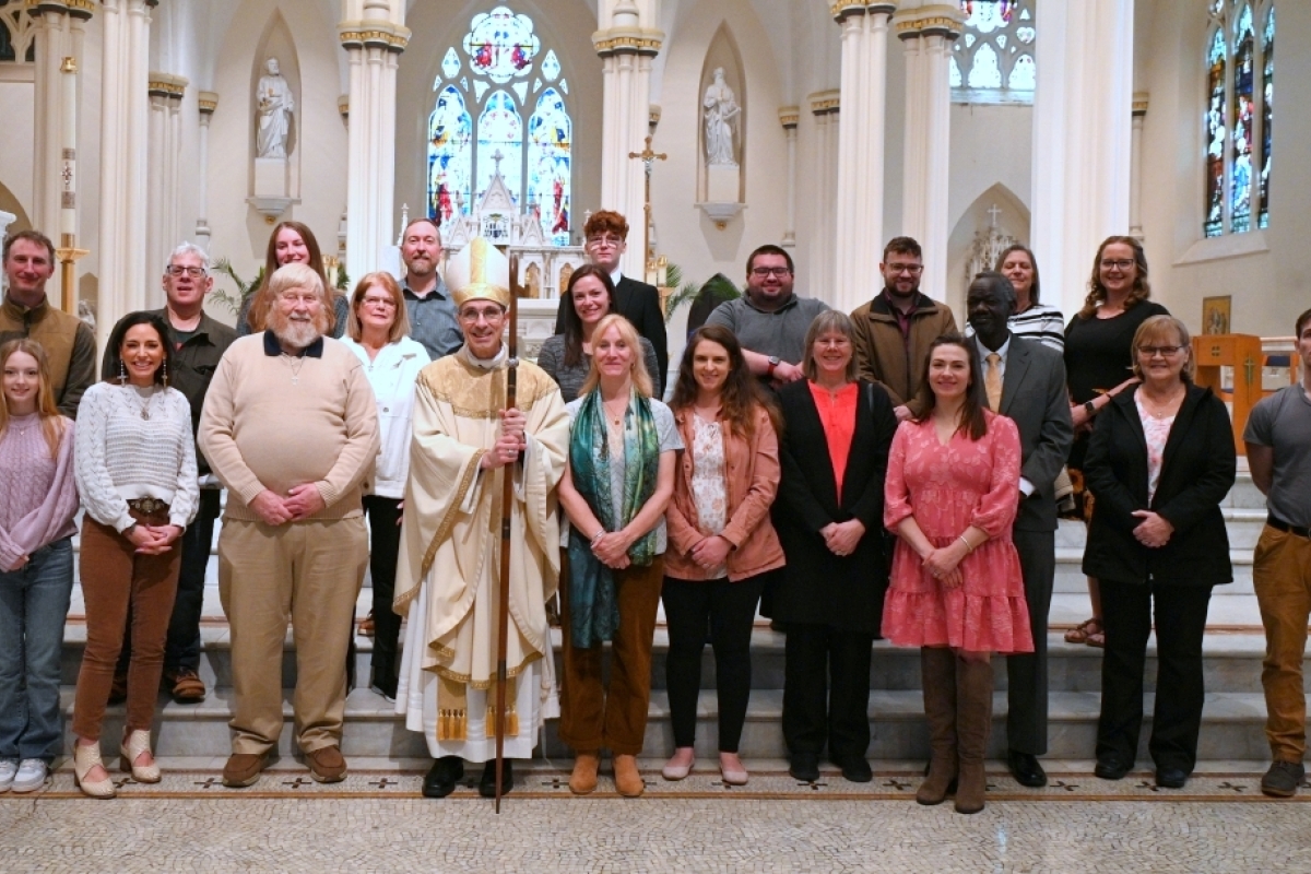 Bishop pictured with large group in front of the altar